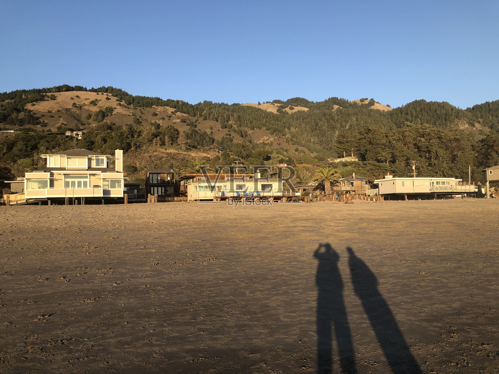 海滩上有两个人的影子照片摄影图片