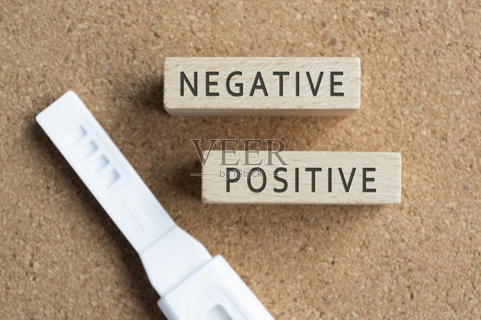 带有验孕棒的木块上有消极和积极的文字。照片摄影图片