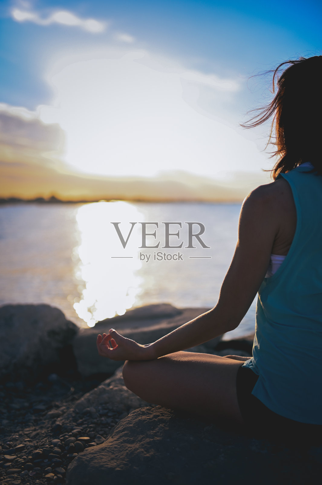 无法辨认的女人站在海边的荷叶上。照片摄影图片