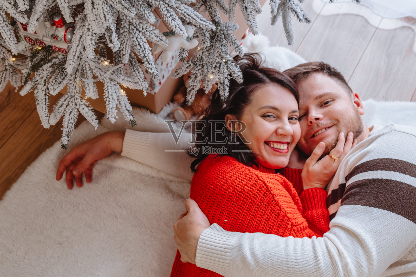 美丽的夫妇在圣诞树旁照片摄影图片