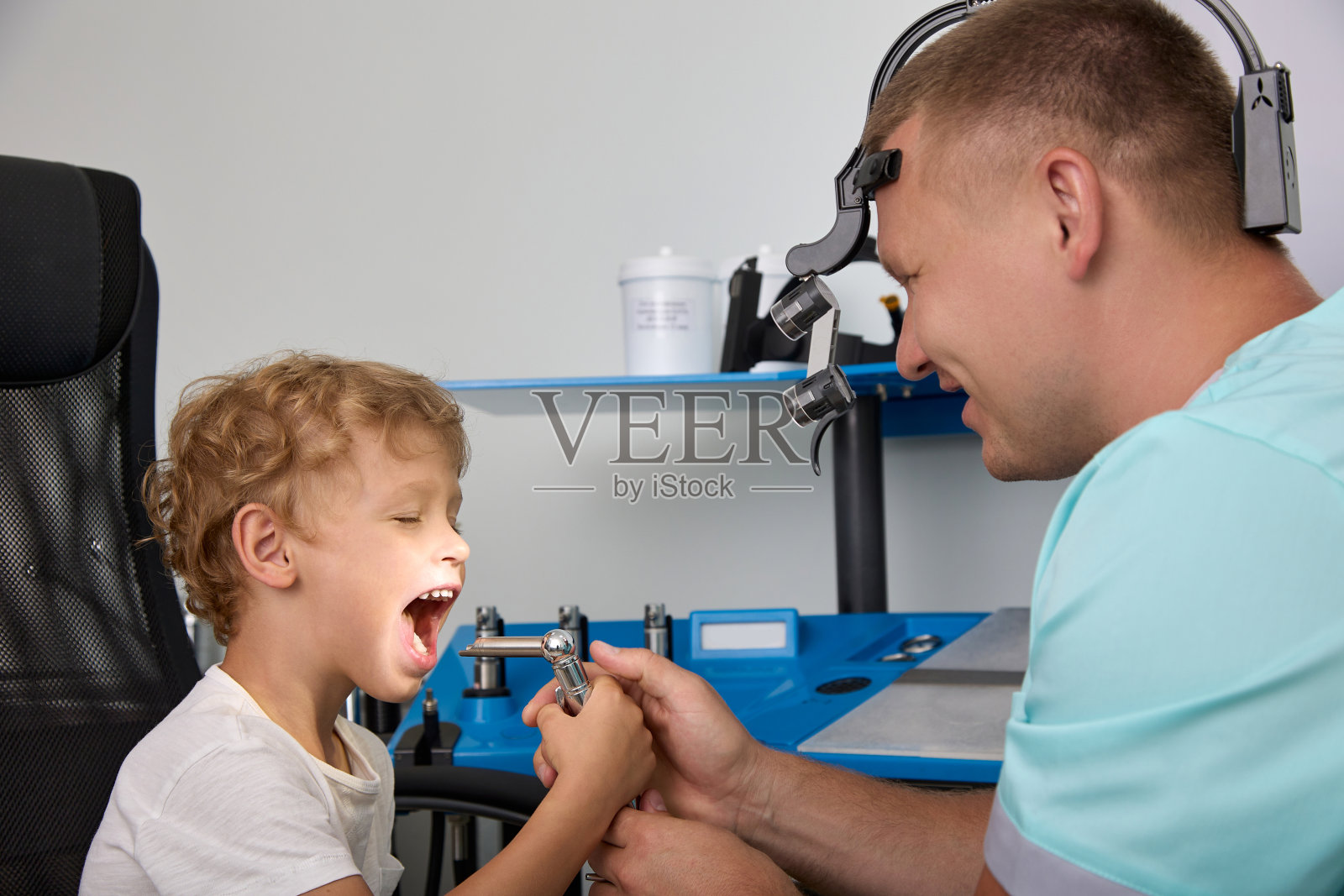 医生儿童医院检查喉部儿童使用原木刀片照片摄影图片