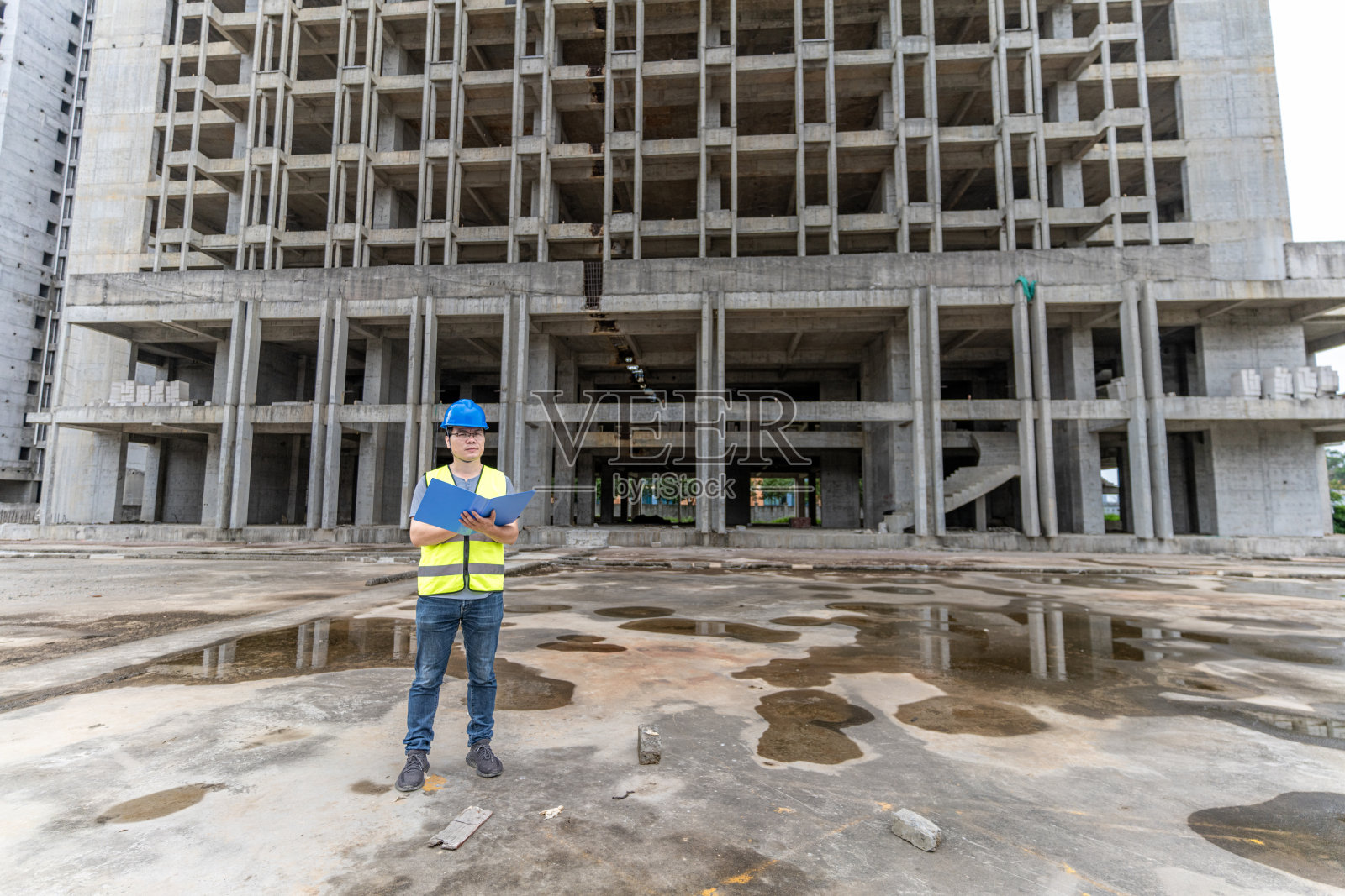 一名男工程师正在施工现场前整理工程材料照片摄影图片