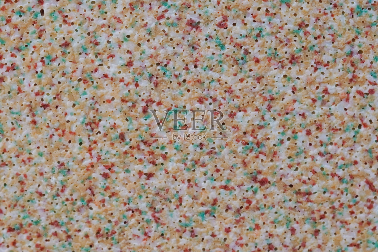 塑料玩具表面多色斑点和小气泡的微距照片。照片摄影图片