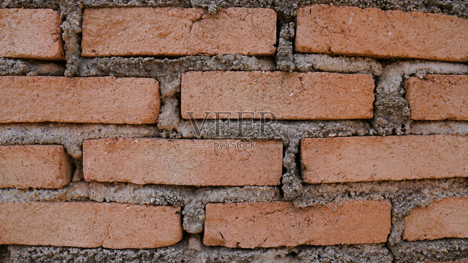 背景图像是一堵由红砖排列而成的墙，看起来很漂亮。照片摄影图片
