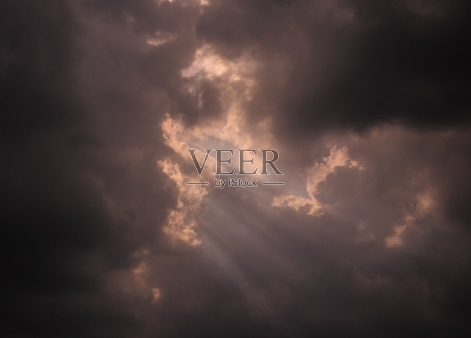 天空中乌云遮住了夕阳的光芒。照片摄影图片