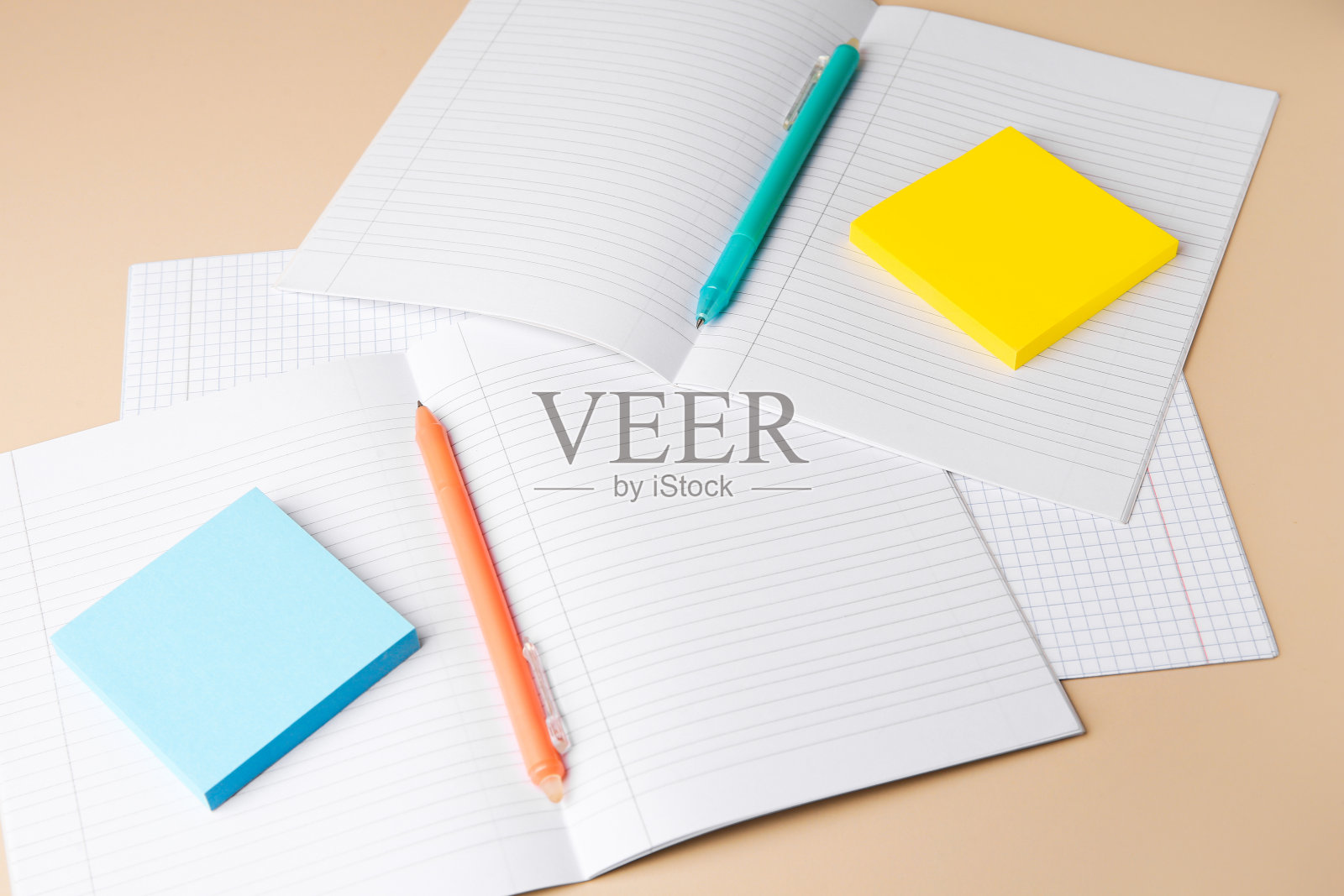 带有可擦笔和米色背景笔记的抄写本照片摄影图片