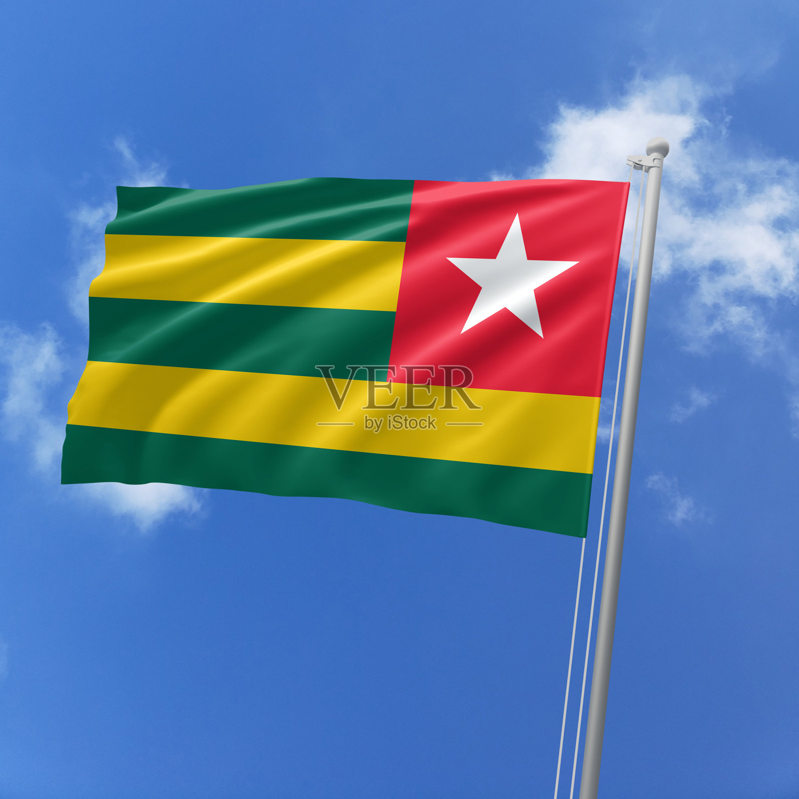 多哥国旗迎风飘扬在天空。照片摄影图片