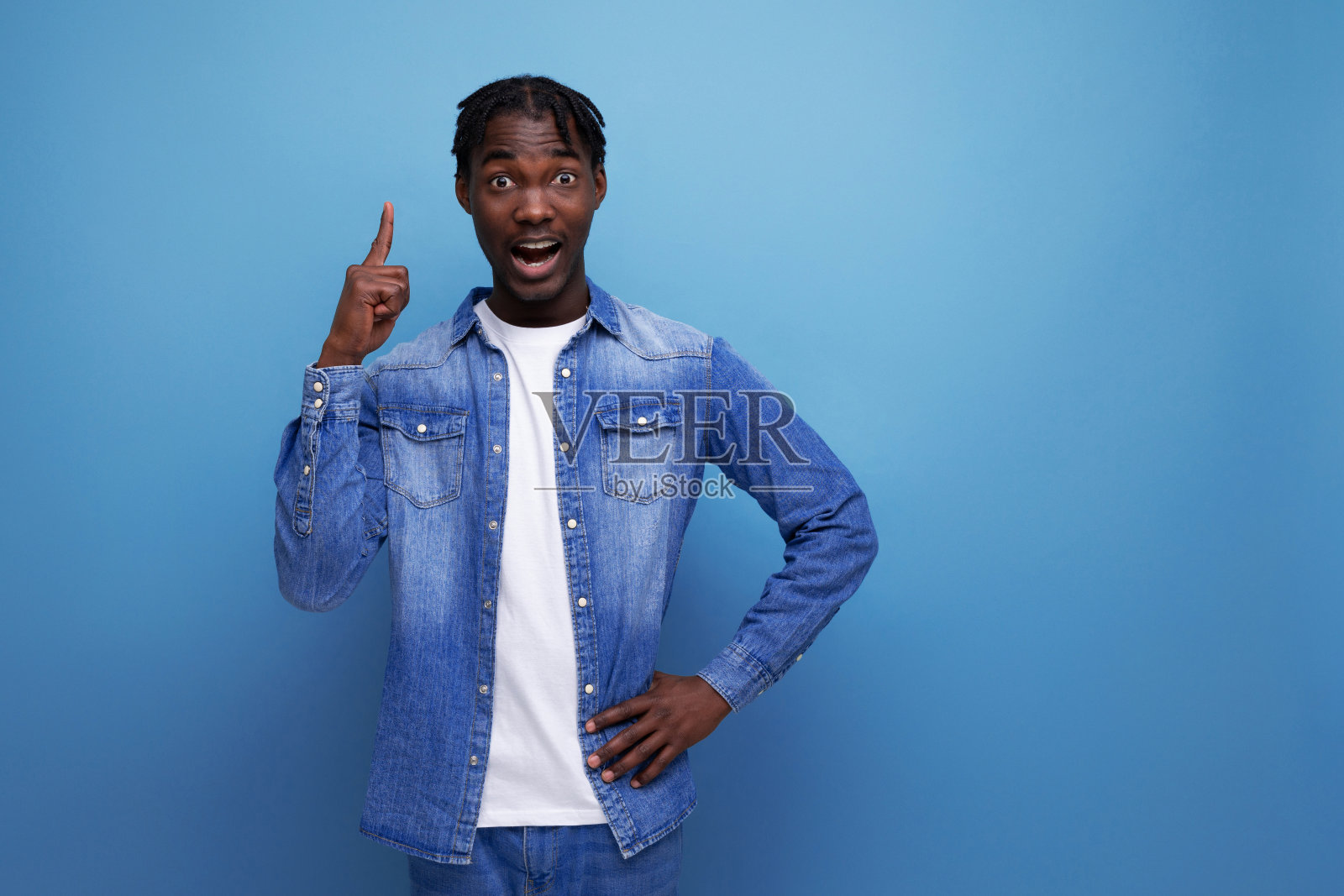 聪明时髦的美国年轻人，留着脏辫，手指指向一边照片摄影图片