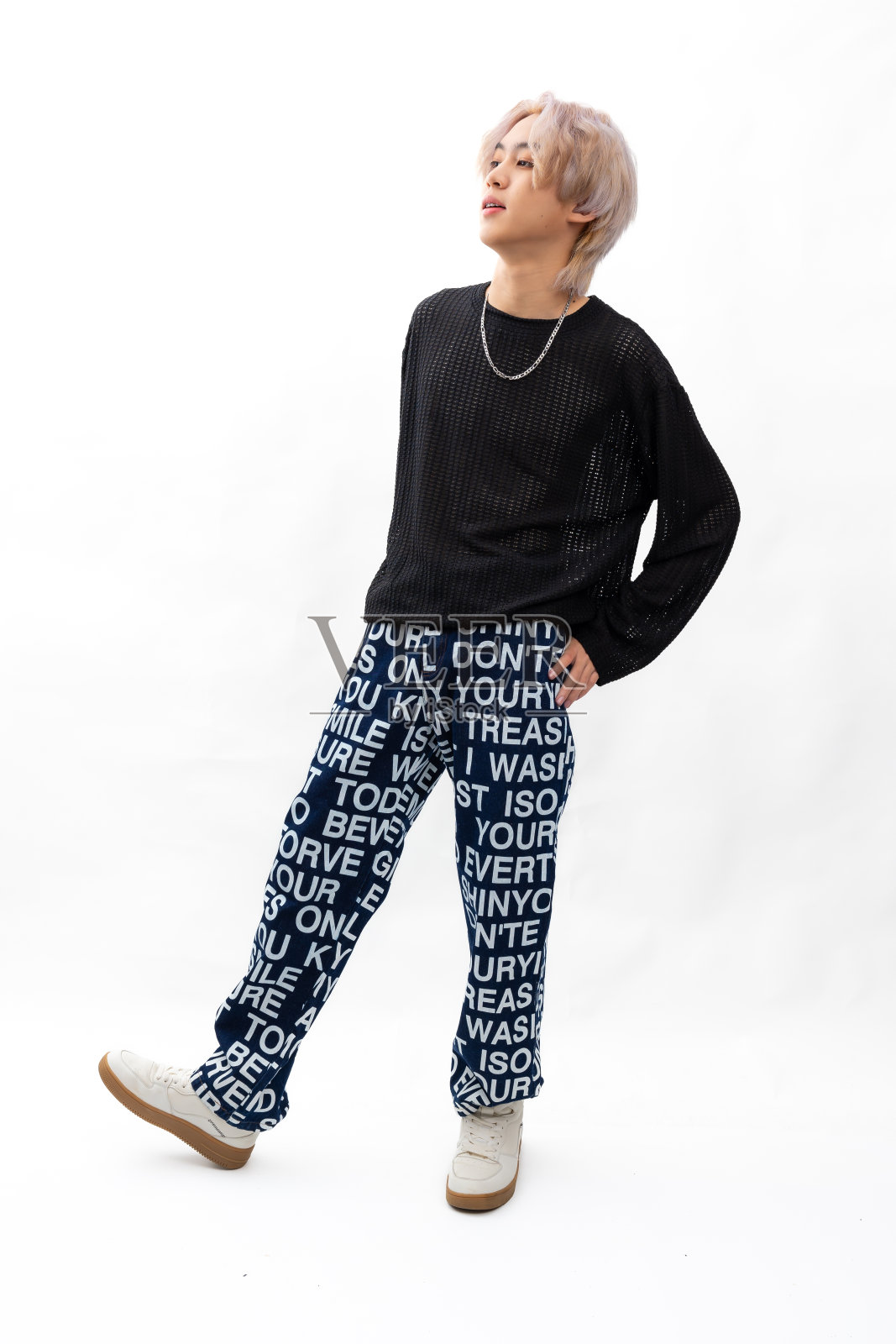 黑色长袖衬衫。亚洲年轻人的时尚肖像。模特、服装和化妆品。年轻的男模特时尚的生活方式，金色的头发在时尚的服装孤立的白色背景照片摄影图片