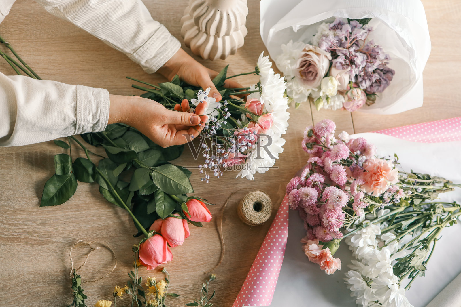 花店老板上班了。制作秋季花卉装饰的妇女照片摄影图片