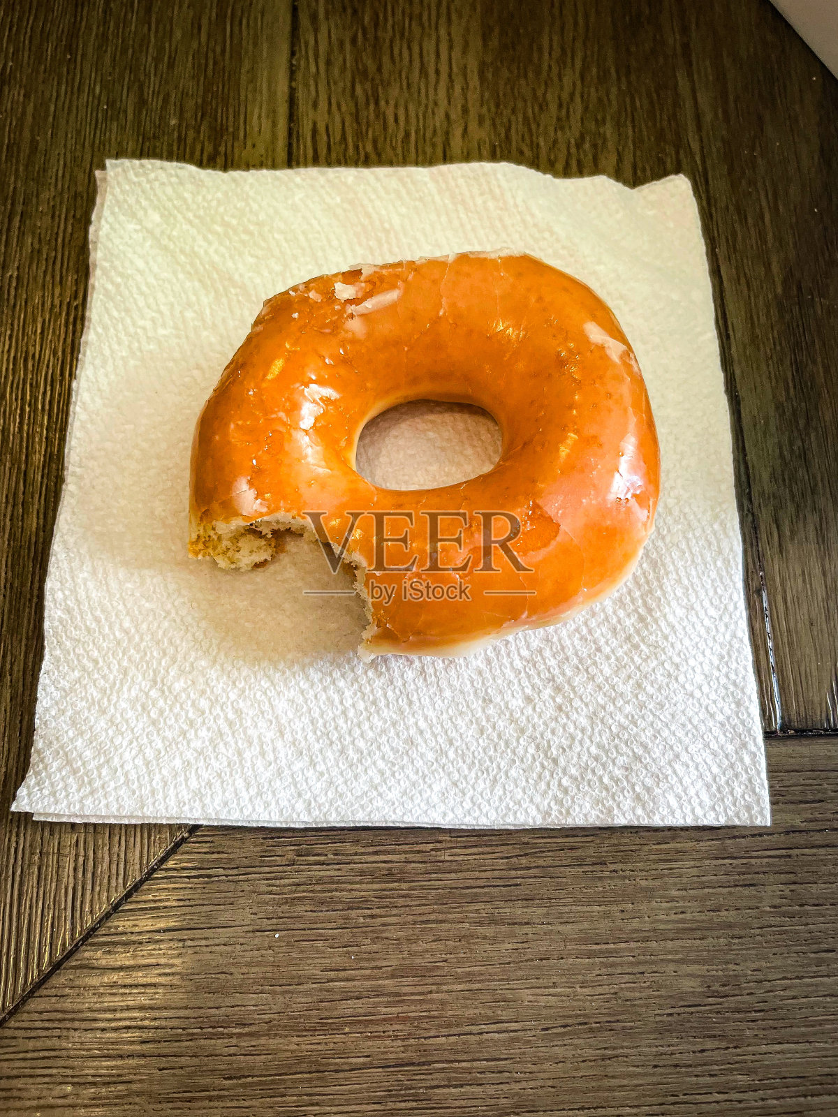 餐巾上的甜甜圈只咬了一口照片摄影图片