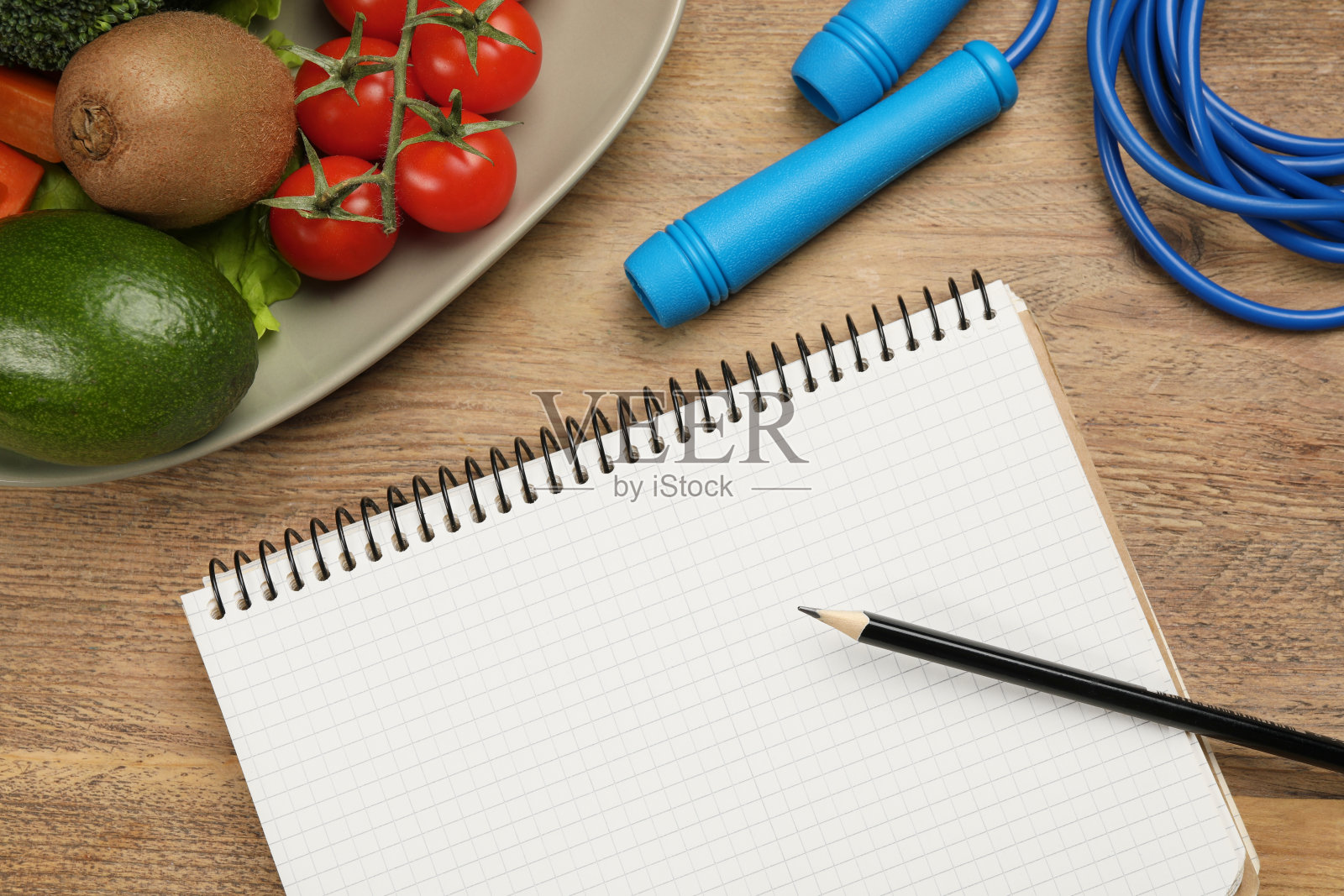 减肥概念。笔记本、跳绳等不同产品放在木桌上，平放照片摄影图片