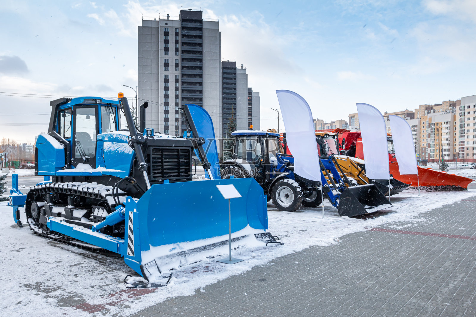 在冬季的一个工业展览会上，推土机和带模板的轮式拖拉机照片摄影图片