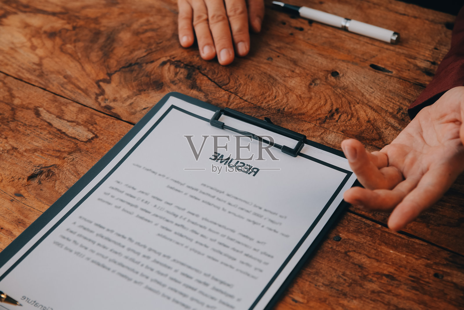 近距离观看办公室面试，重点关注简历写作技巧，雇主审查准备好的熟练求职者的优秀简历，招聘人员考虑申请，人力资源经理做出雇佣决定照片摄影图片