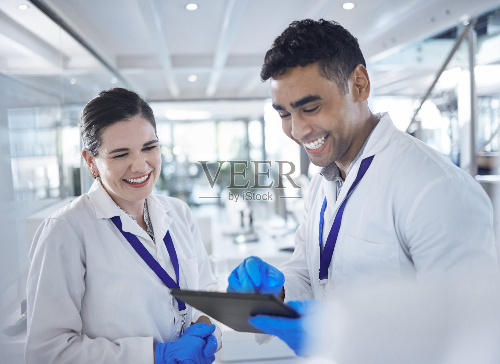 药片，科学家和快乐的实验室保健，手套和医学研究疫苗治疗。女性，男性和多样性触摸屏和药物分析与科学合作照片摄影图片