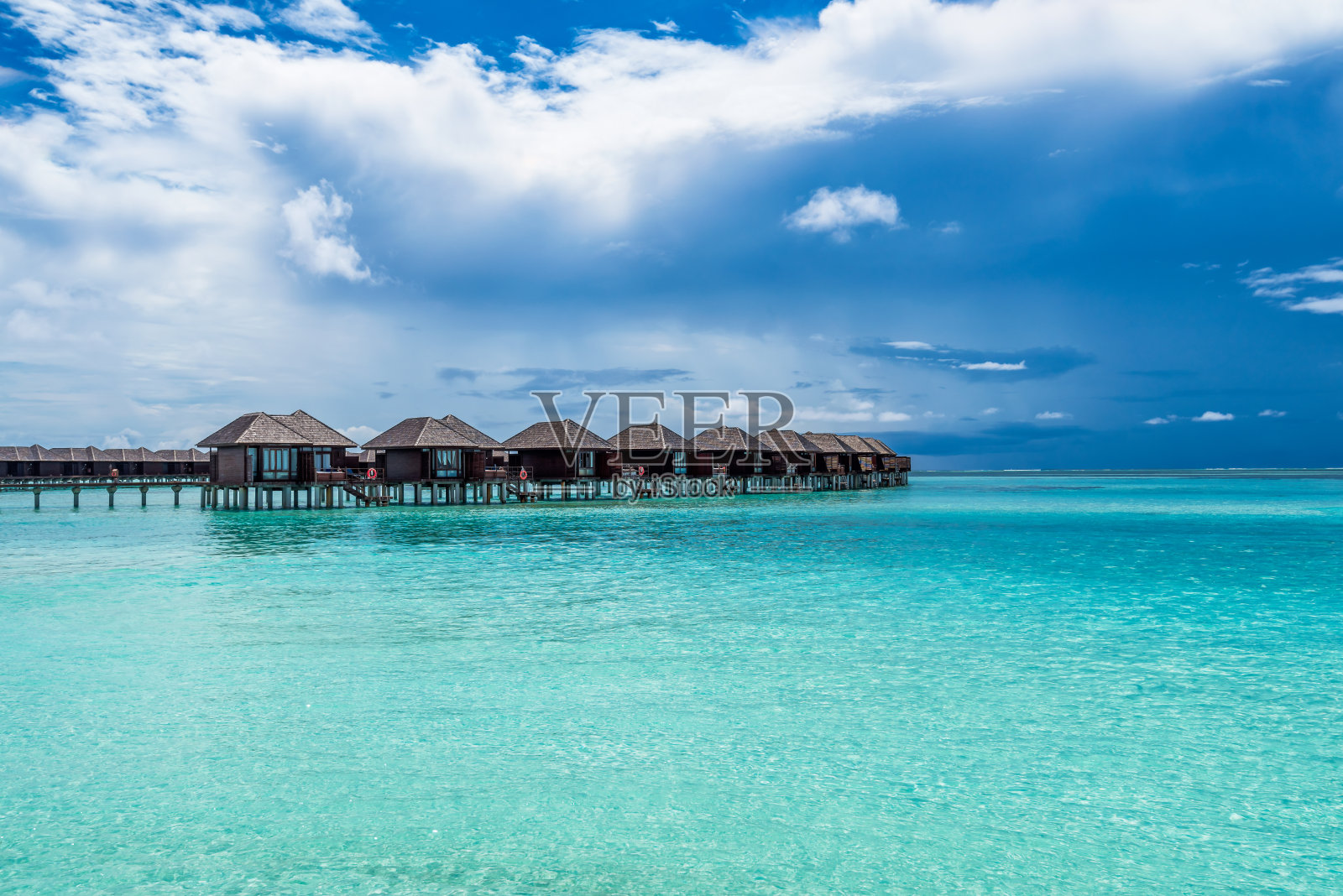 马尔代夫的水别墅风景优美，绿松石般的水和戏剧性的天空照片摄影图片