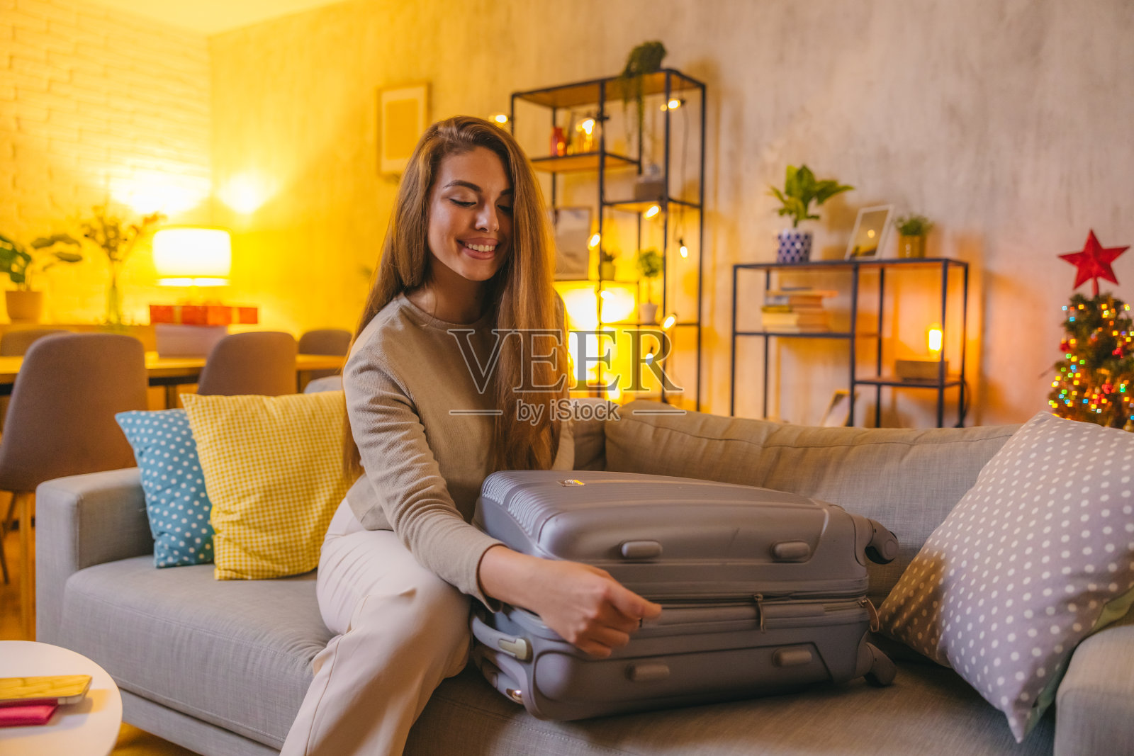 美丽的年轻女子正在收拾行李准备度假照片摄影图片