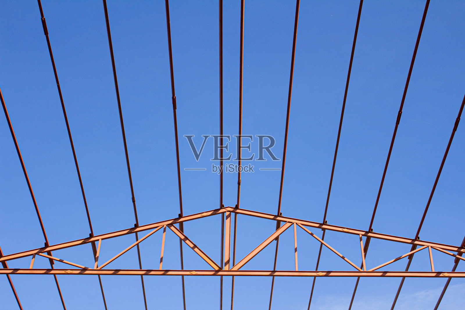 在蓝天的背景下，使用起重机和安装人员安装机库金属结构照片摄影图片