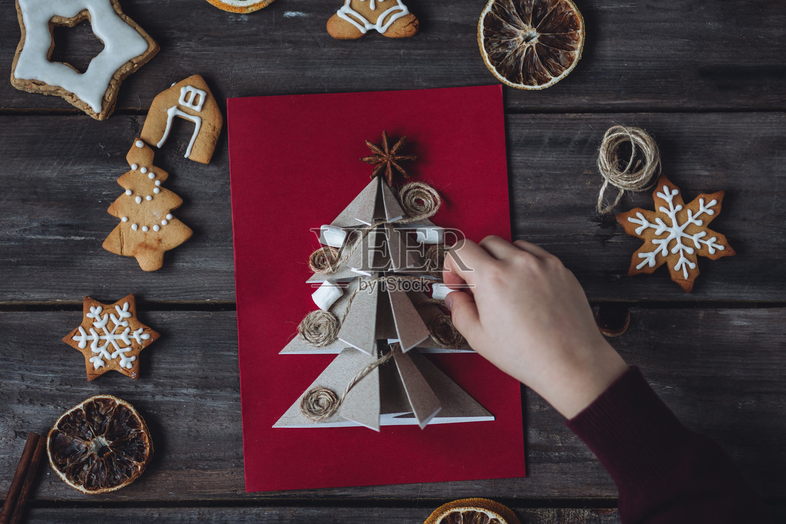 圣诞节理念休闲，合家时光，做自己的礼物。小男孩拿着用可回收的天然材料制作的手工卡片，零浪费，可持续的生活方式，爱好照片摄影图片