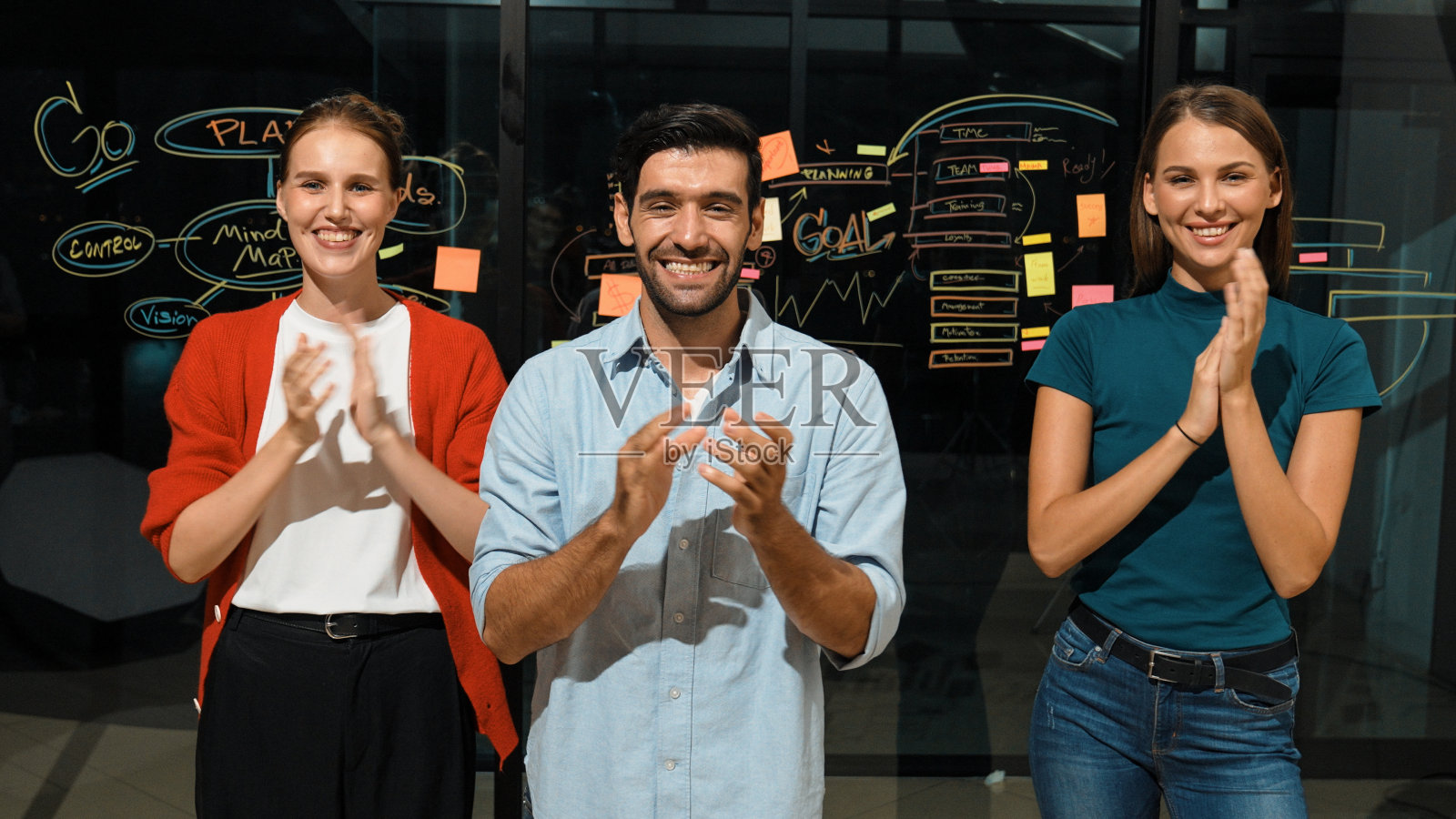 一群商人拍手庆祝项目成功。窗饰照片摄影图片