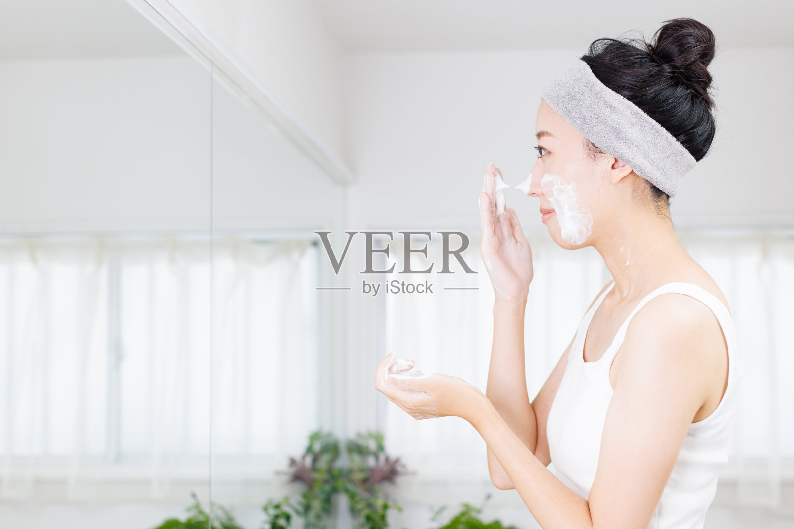年轻的亚洲女性使用洁面泡沫照片摄影图片