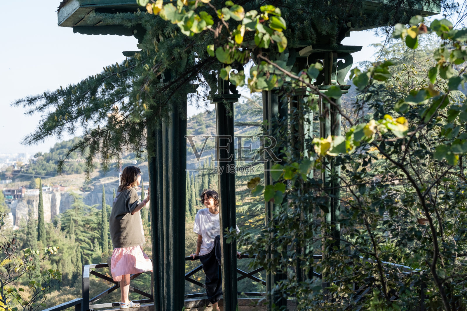两个女孩在第比利斯植物园辛苦散步后交谈照片摄影图片