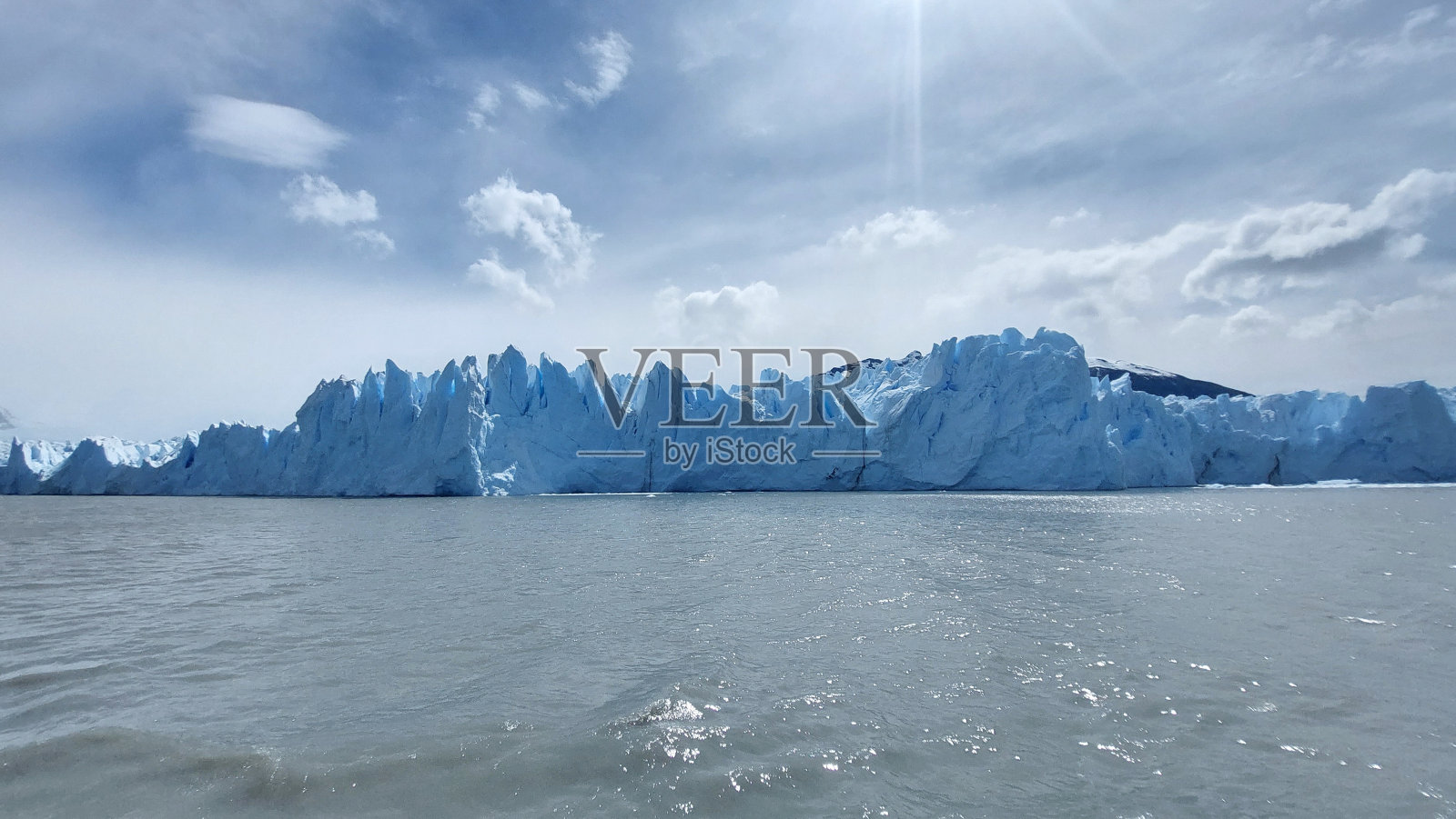 从它脚下的海中可以看到佩里托莫雷诺冰川壮观的冰墙照片摄影图片