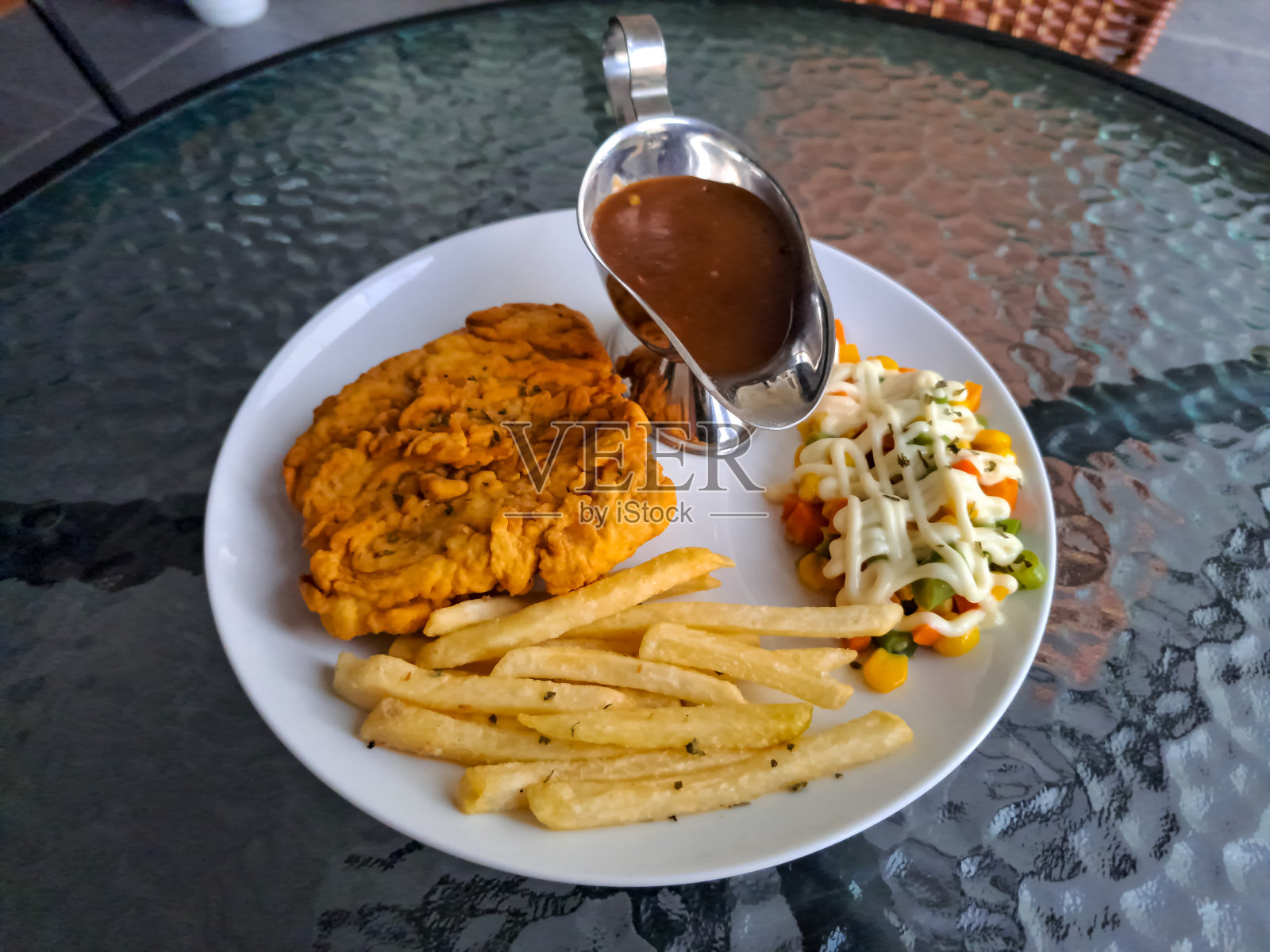 脆皮多利牛排配多利鱼片，薯条和混合蔬菜与蛋黄酱。食品菜单照片摄影图片