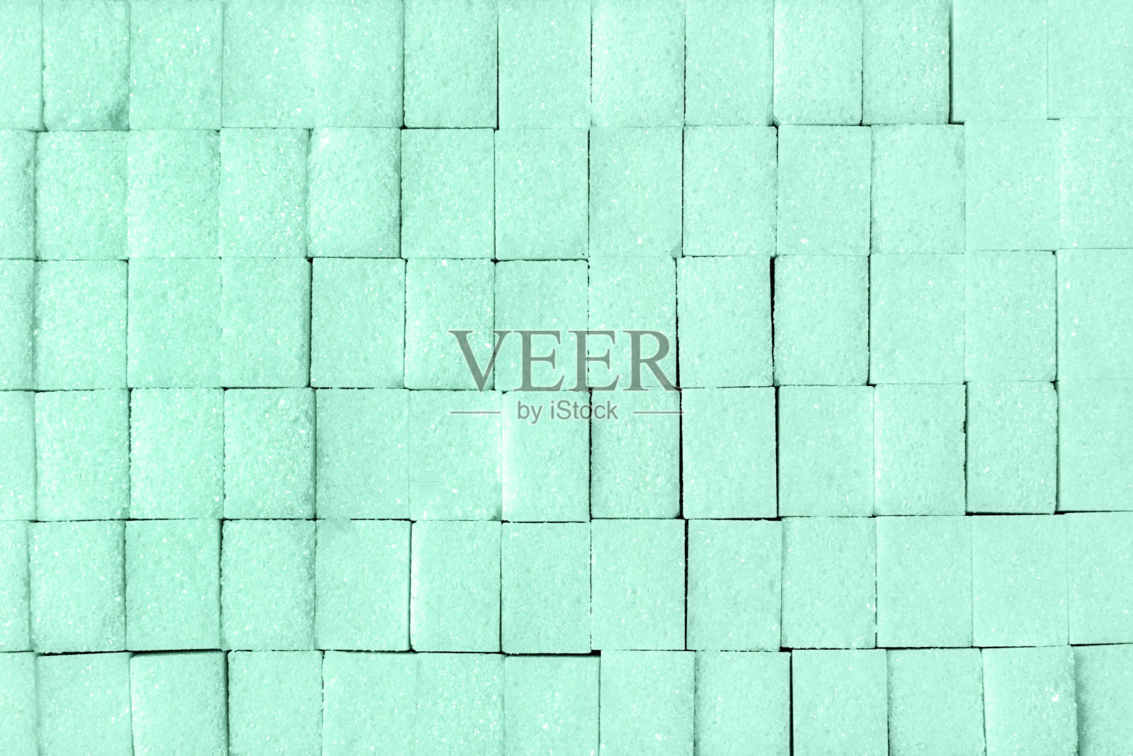 平铺糖块，调在新薄荷的颜色，背景。照片摄影图片