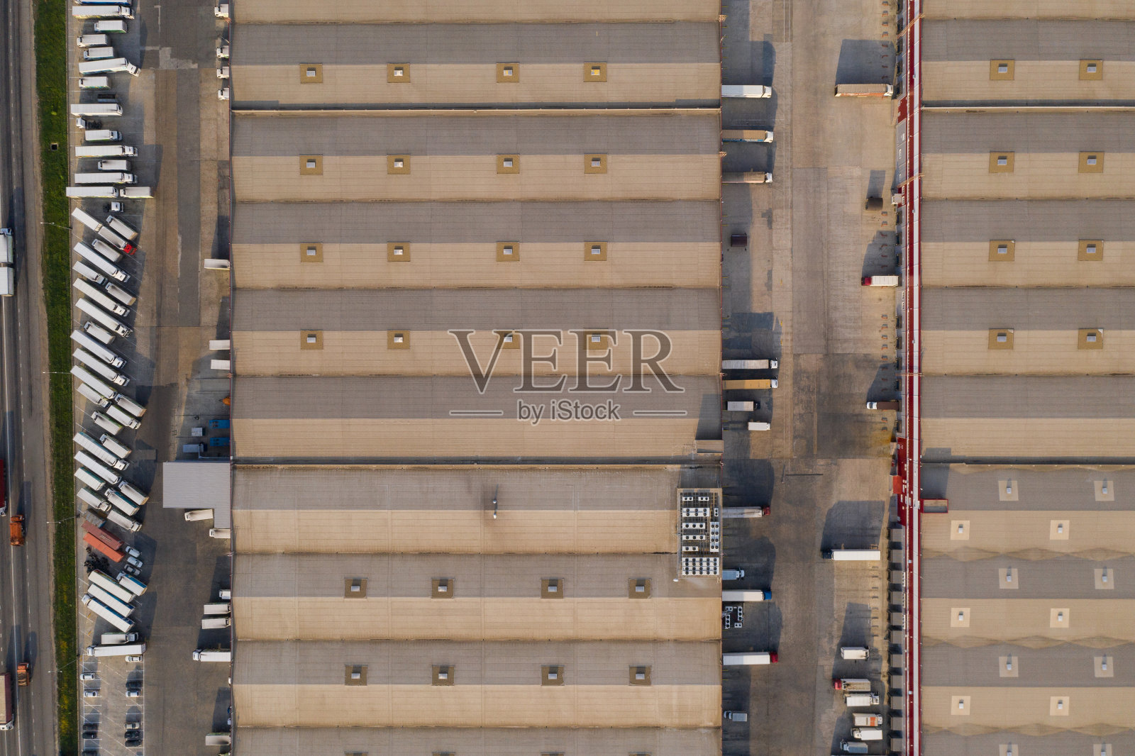 大型物流中心鸟瞰图。许多卡车停在仓库里。照片摄影图片