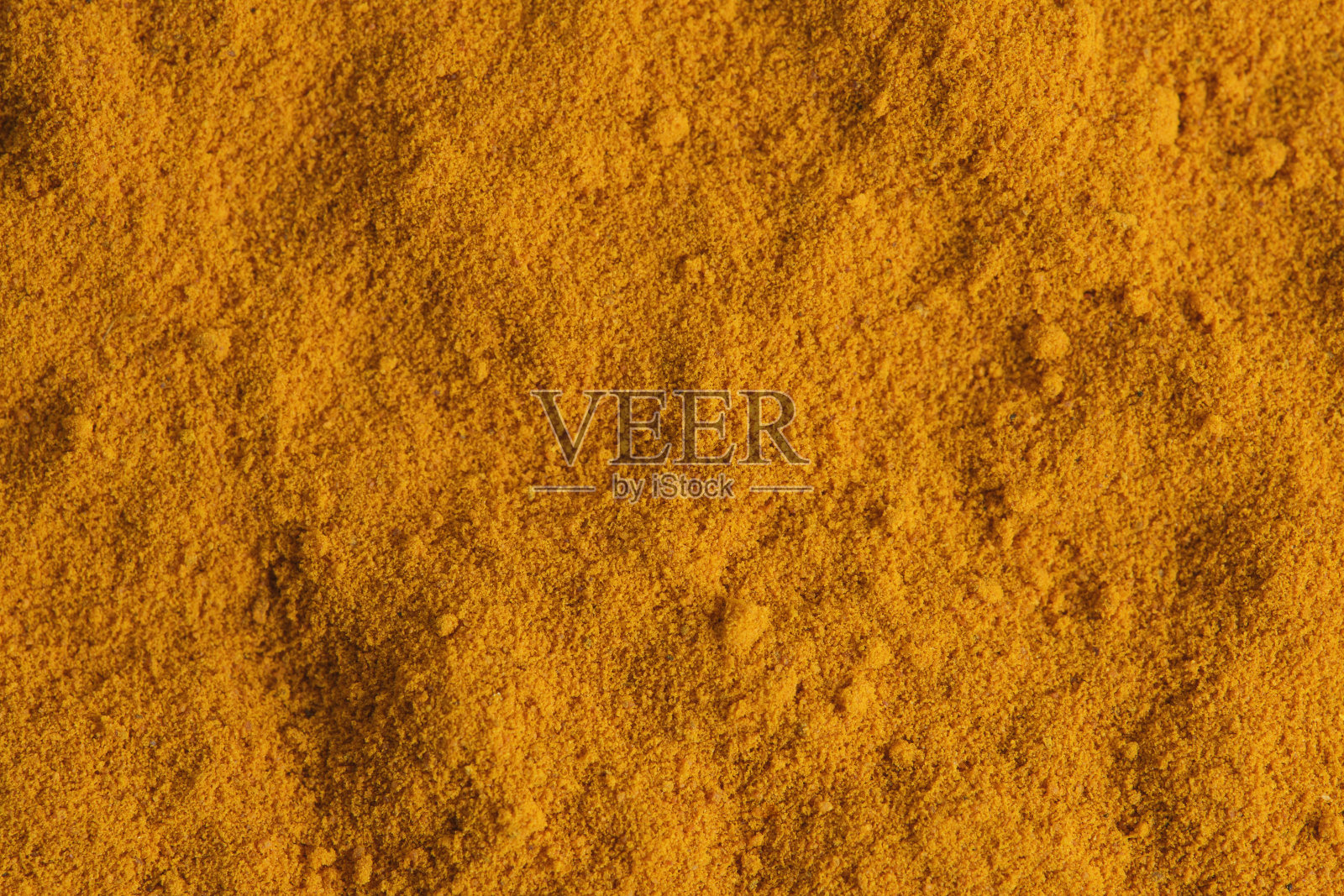 姜黄香料背景的微距摄影。照片摄影图片