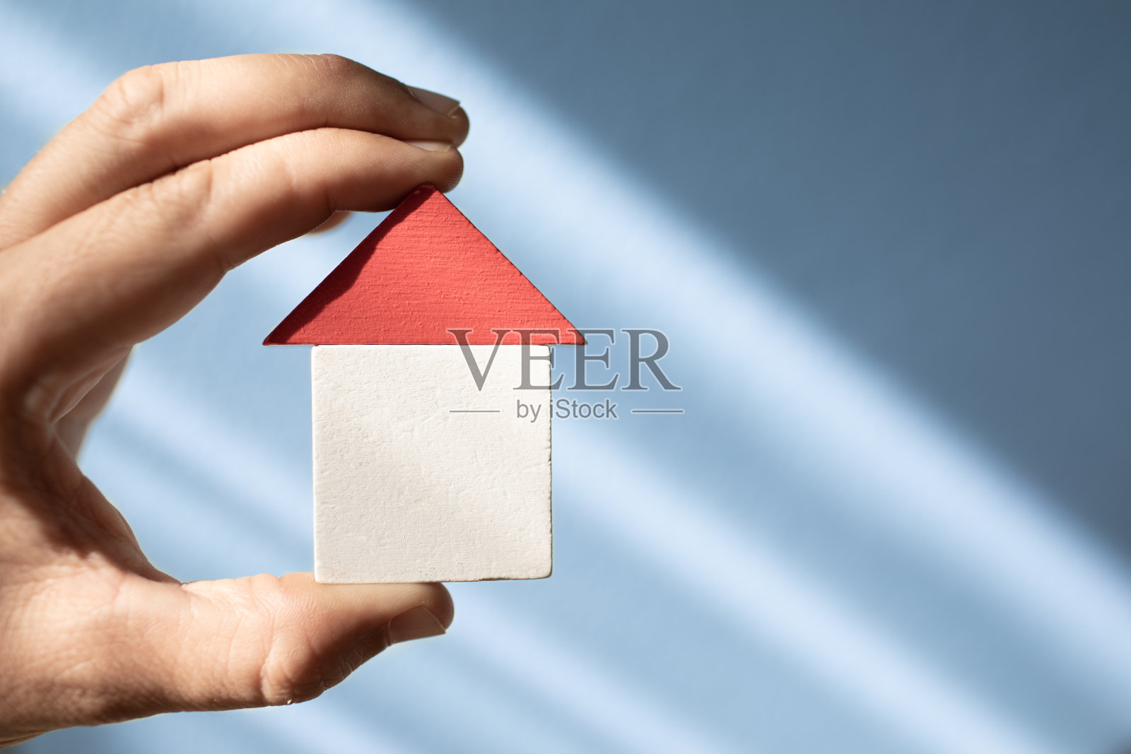 展示小房子的手。买卖房子。照片摄影图片