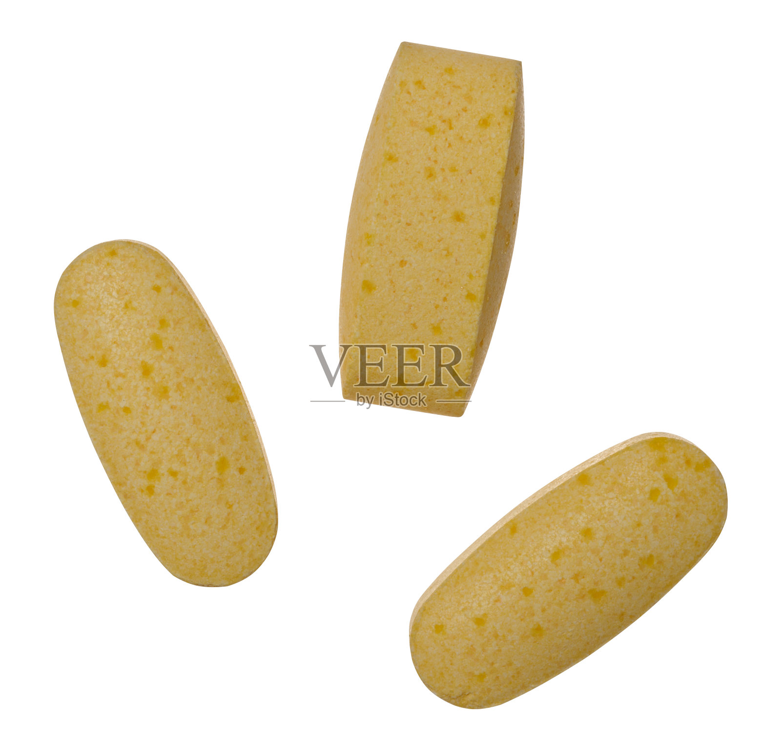 黄色椭圆形片剂在孤立的背景照片摄影图片