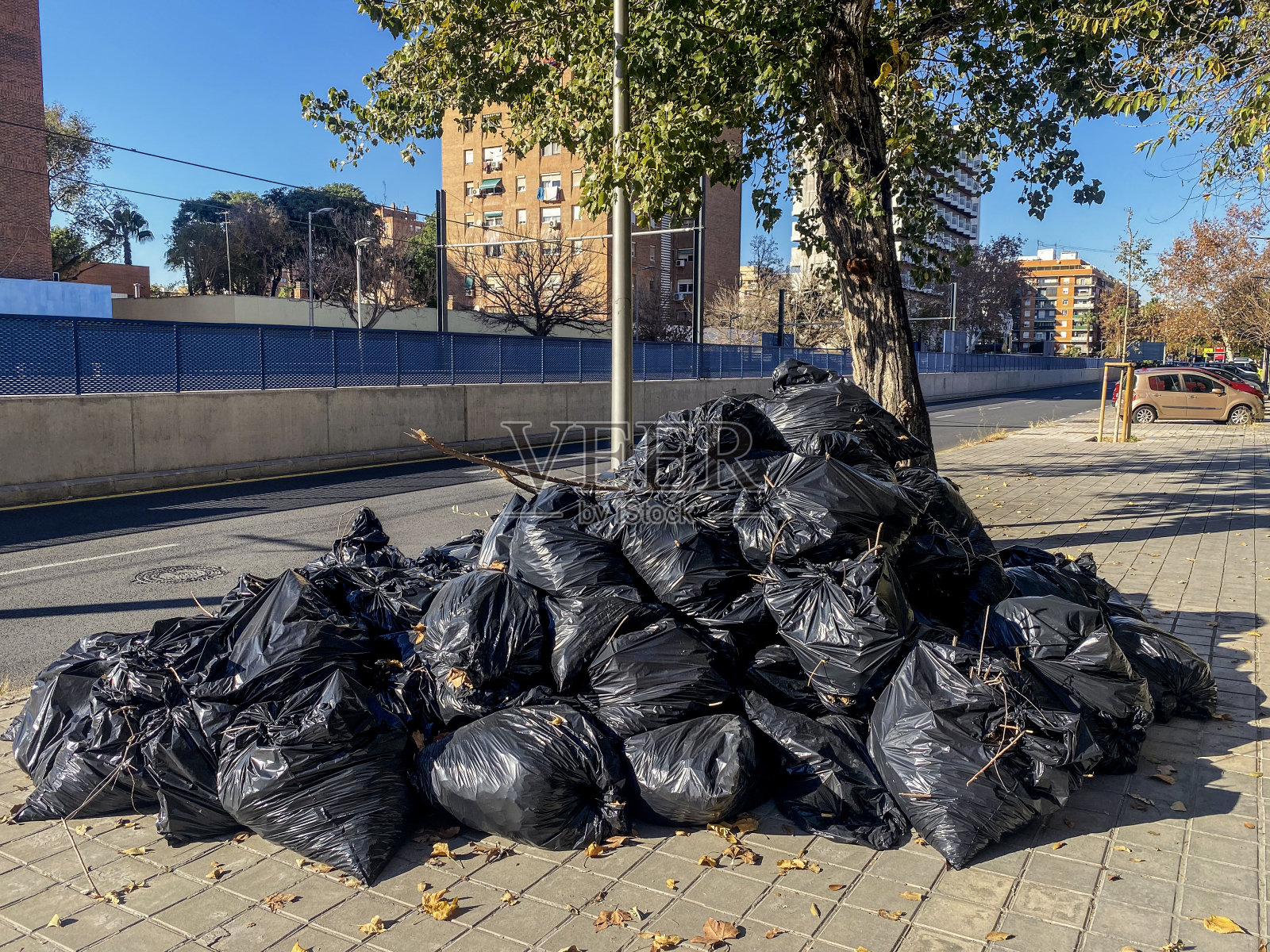 人行道上堆满了黑色塑料袋照片摄影图片
