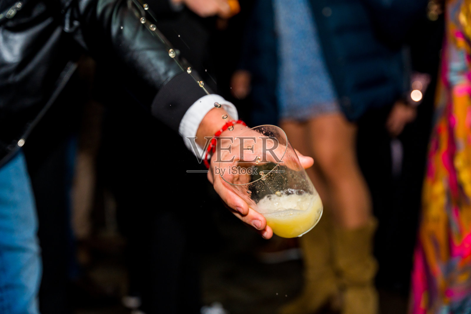 在苹果酒屋举行的活动中，一只手拿着一杯苹果酒的细节，苹果酒是巴斯克地区的一种酒精饮料照片摄影图片