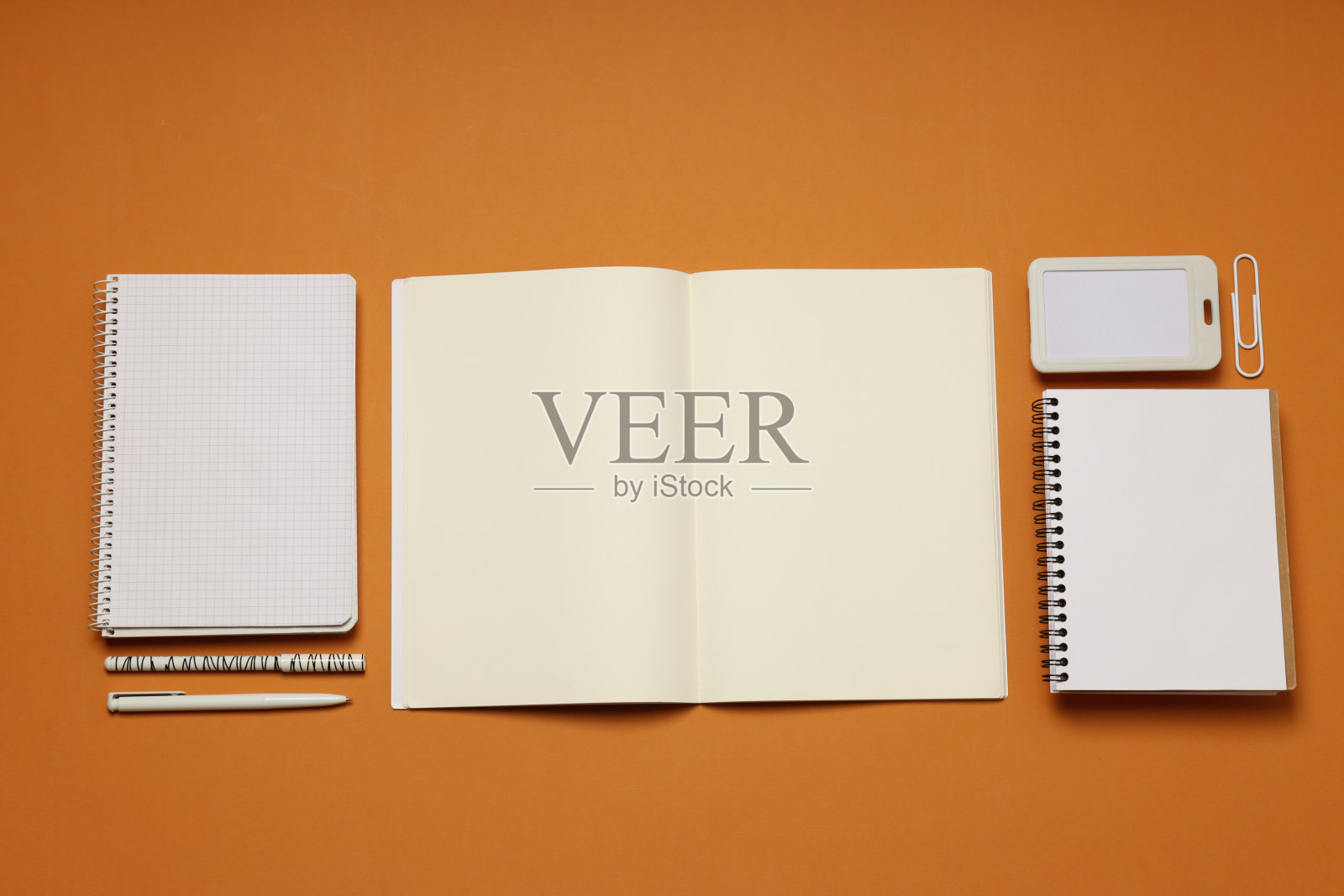 在棕色的背景上摆放着不同的办公配件照片摄影图片