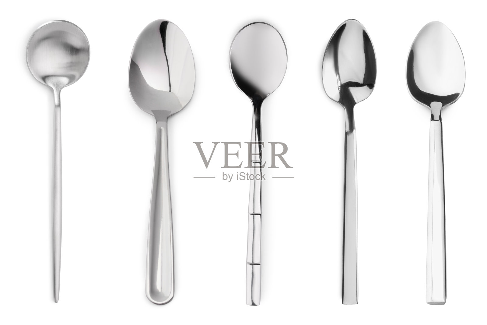白色背景上不同风格的银色勺子照片摄影图片