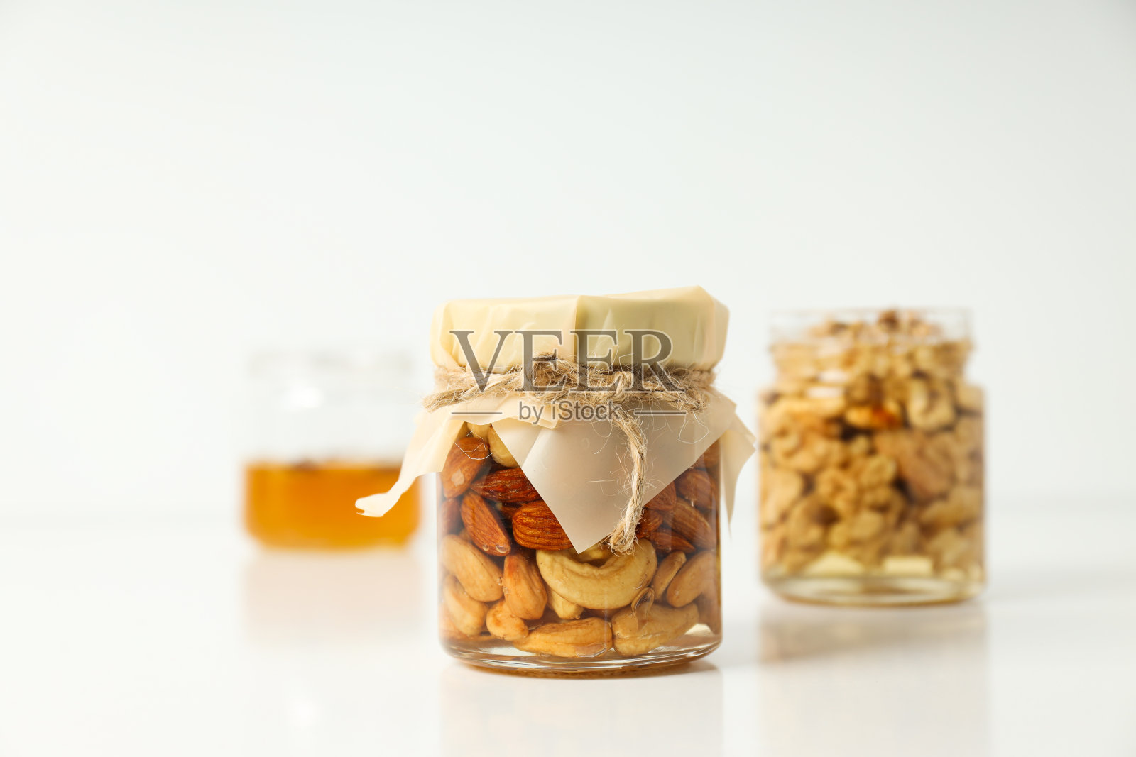 美味的概念和甜的食物-蜂蜜与坚果照片摄影图片