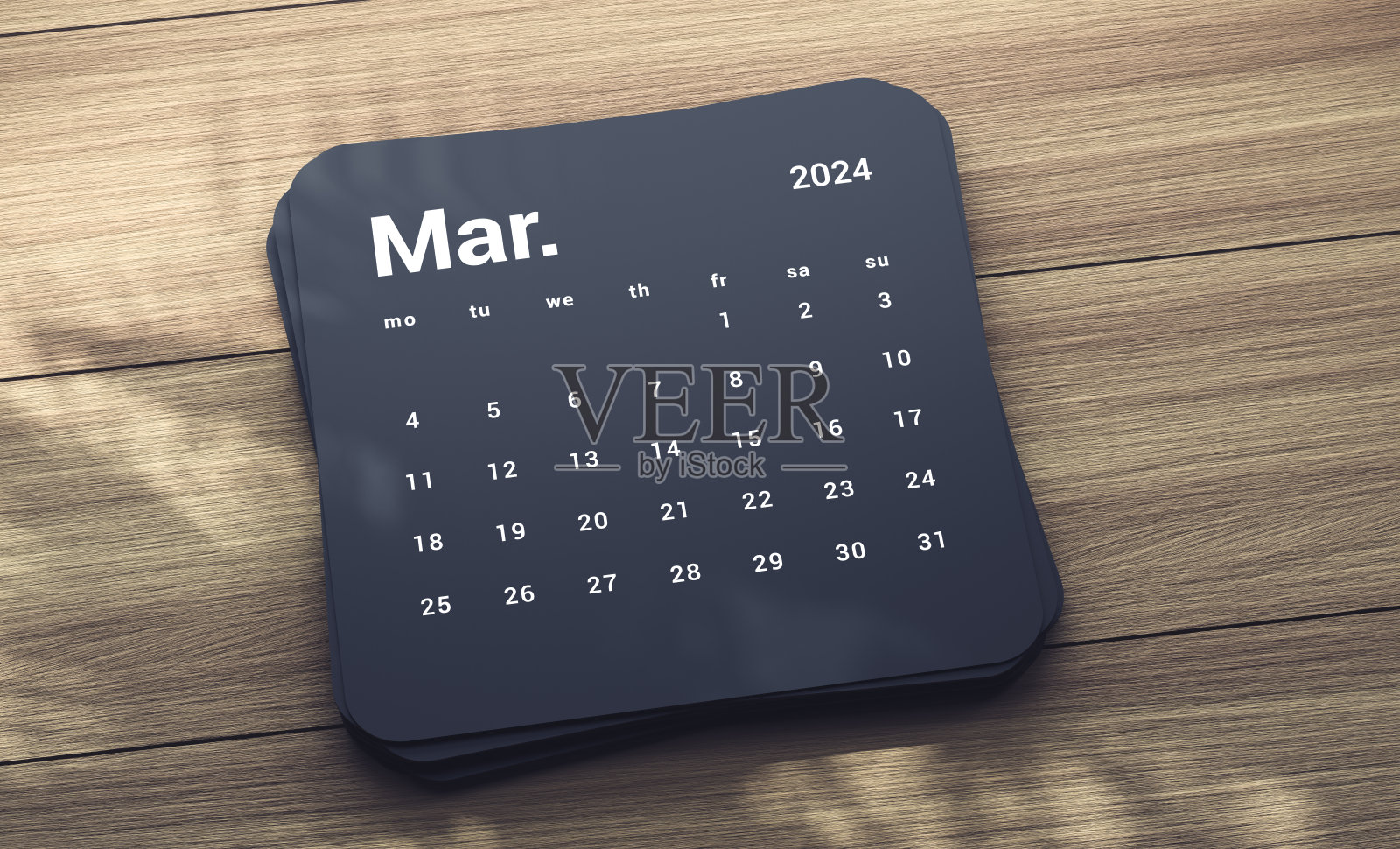 木桌上的2024年三月日历照片摄影图片