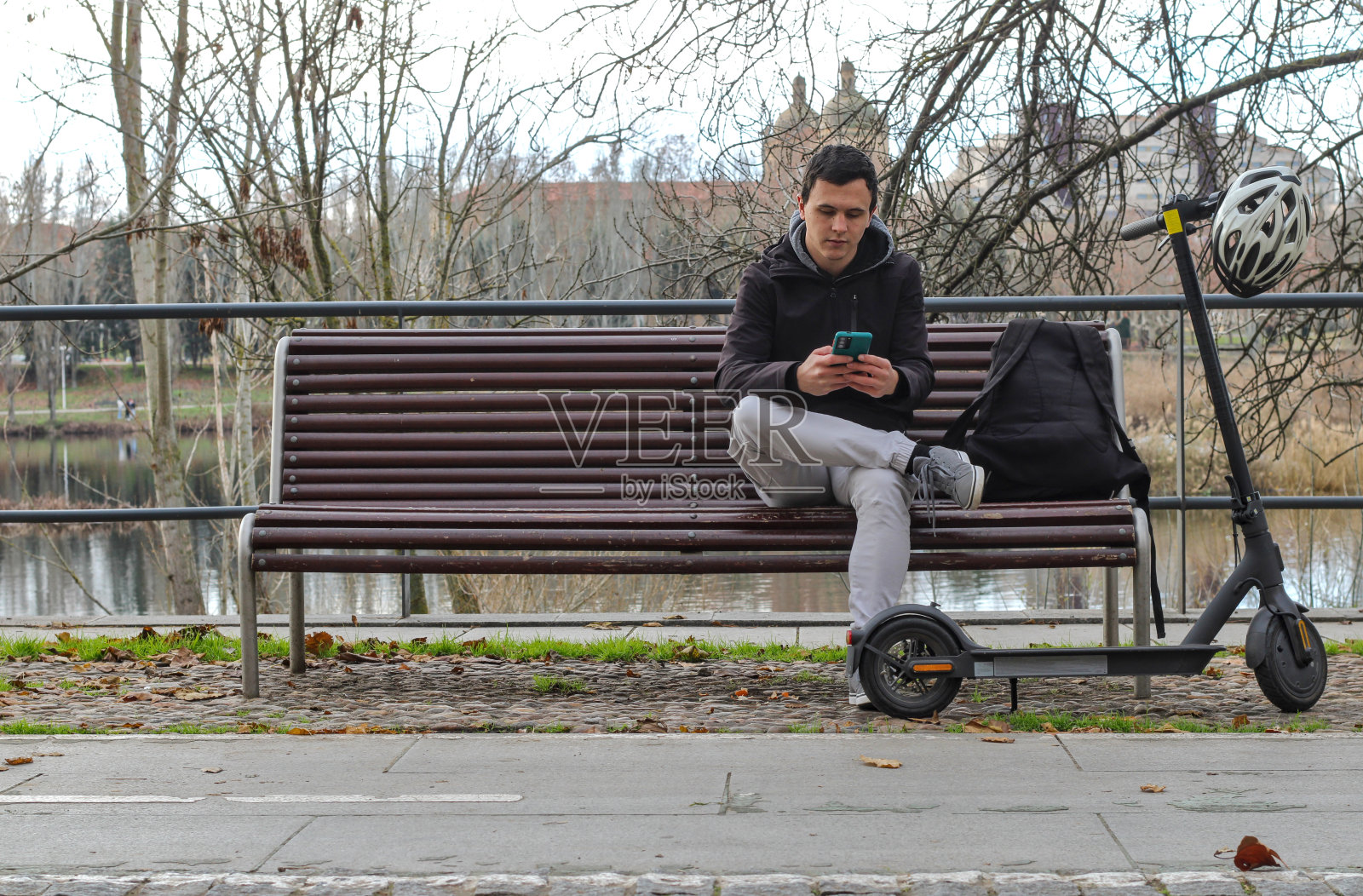 一个年轻的白人坐在长凳上照片摄影图片