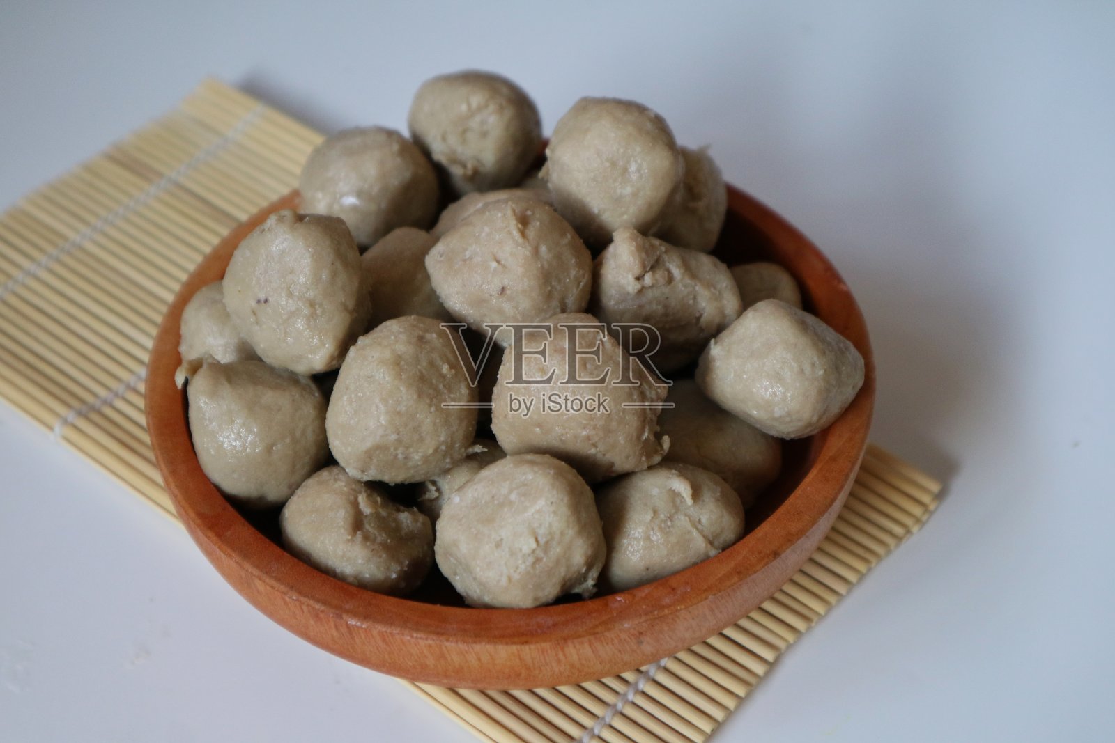 孤立的巴索或印尼肉丸木制碗和白色背景。准备做肉丸汤。有选择性的重点。照片摄影图片