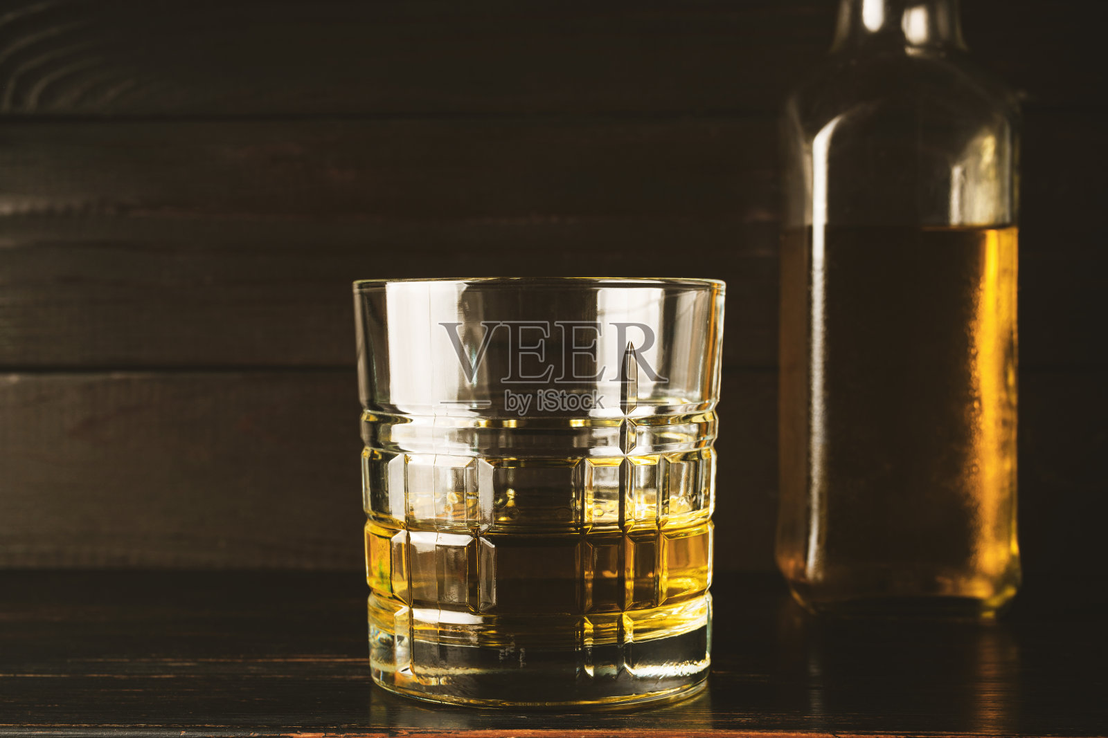 木桌上装有酒精饮料、威士忌、白兰地、朗姆酒的玻璃杯照片摄影图片