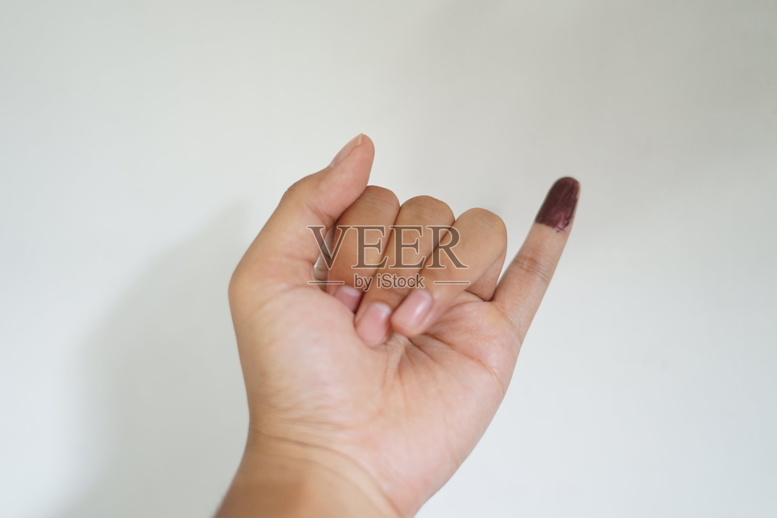 用墨水涂抹小指作为在印度尼西亚选举中投票的证明，或被称为Pemilu照片摄影图片