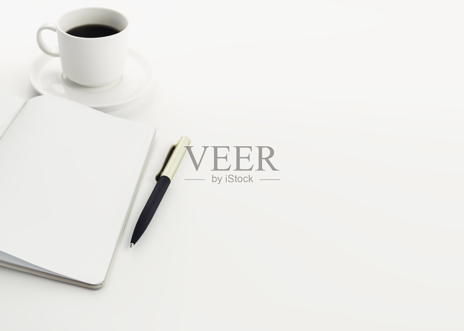 打开笔记本，在白色的桌子上放一支笔和一杯咖啡，留出文字的空间照片摄影图片