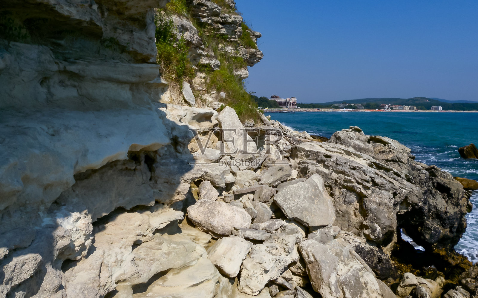在保加利亚索佐波尔附近的一个陡峭的岩石海岸上，石头落入大海照片摄影图片