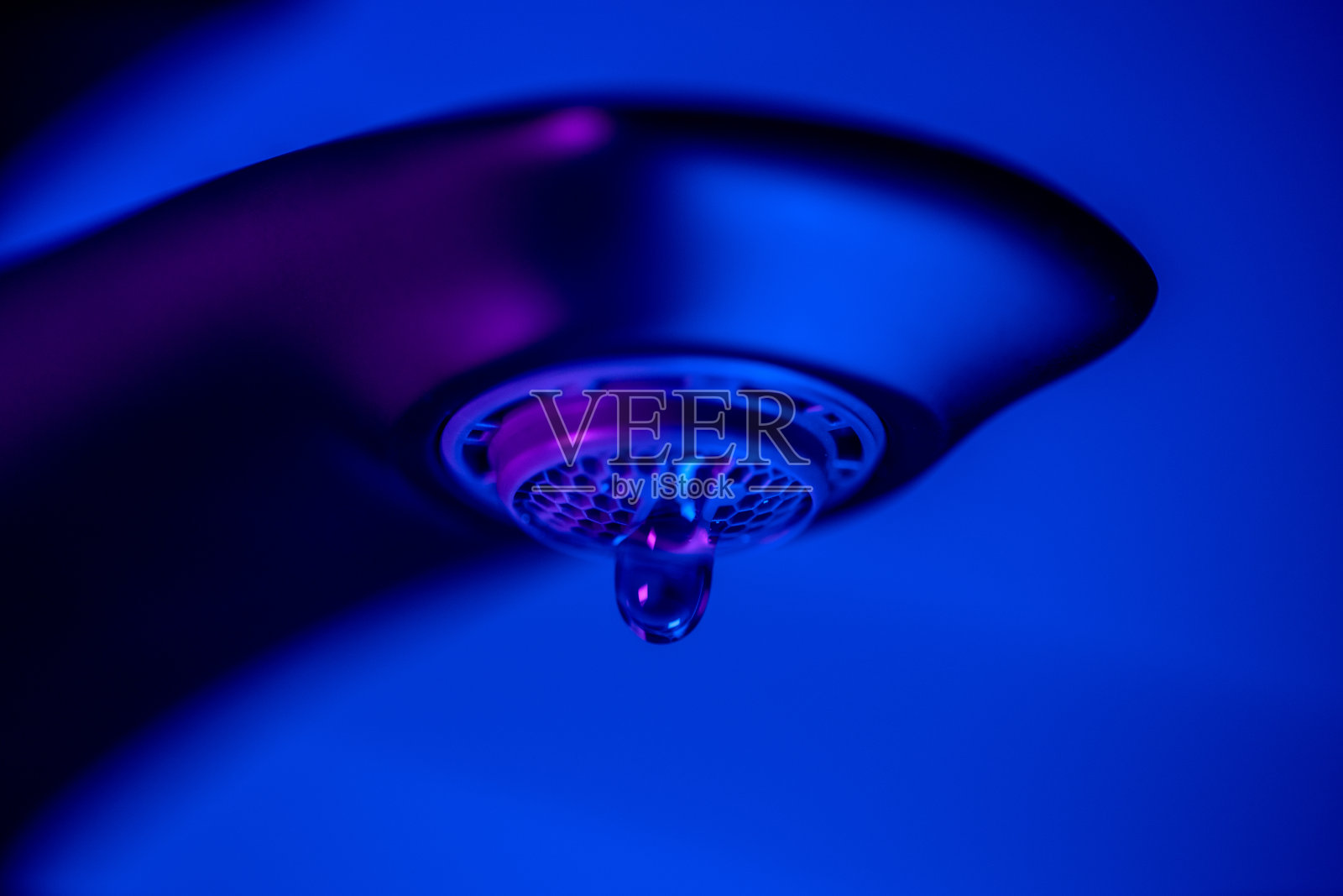 漏水的水龙头有水滴，霓虹色的形象照片摄影图片