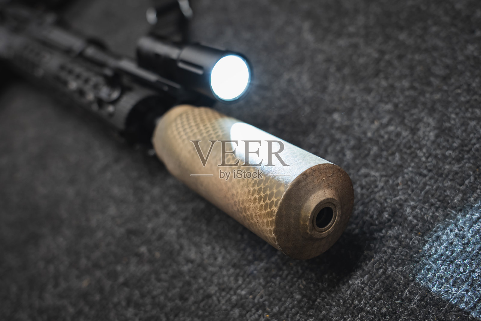 战术武器，带消音器的步枪，打开手电筒，特写照片。照片摄影图片