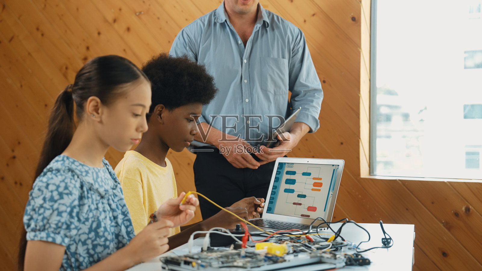 老师站着讲解编程和机器人构造。启迪。照片摄影图片