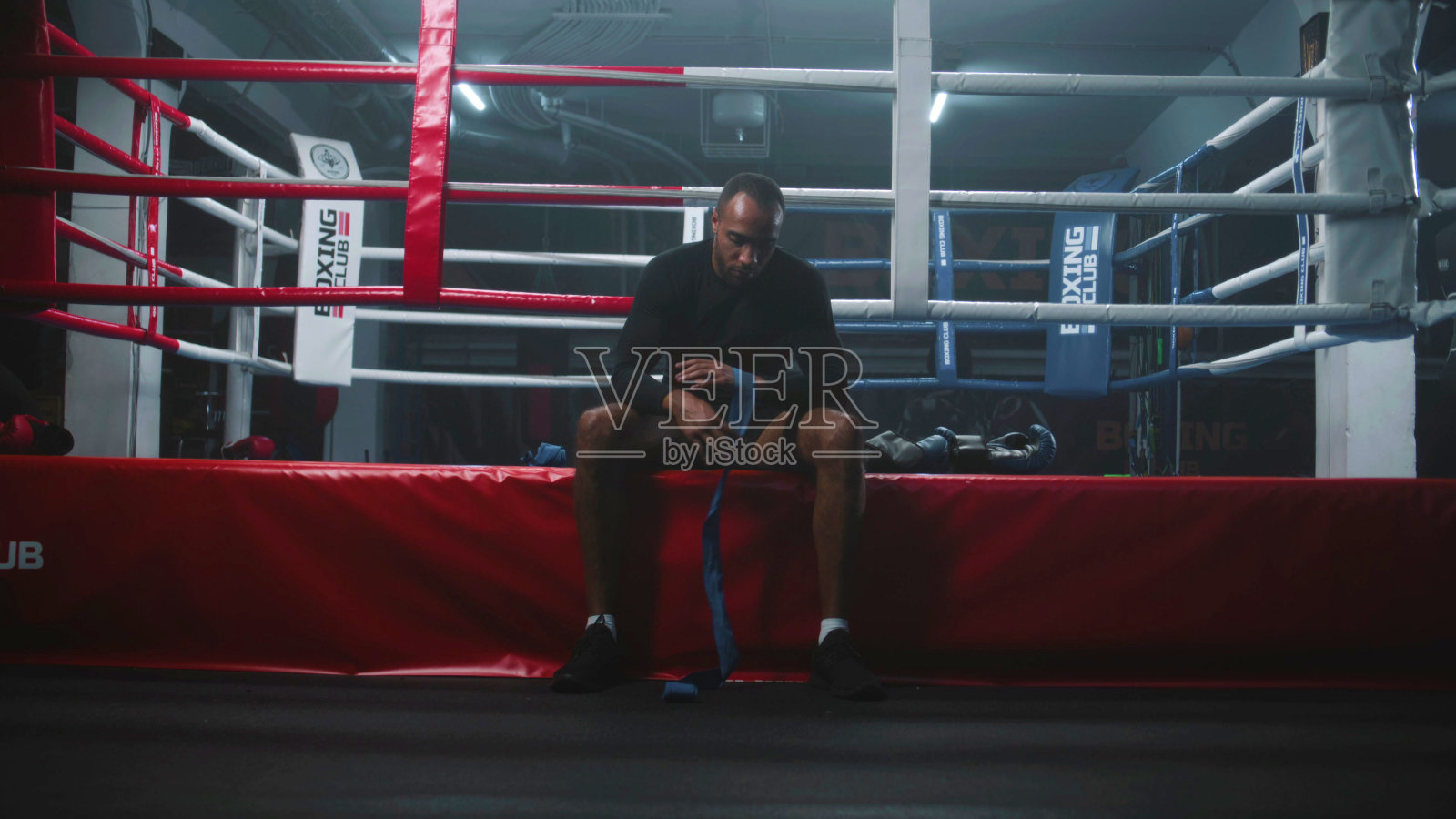 非裔美国拳击手坐着用绷带包扎双手照片摄影图片