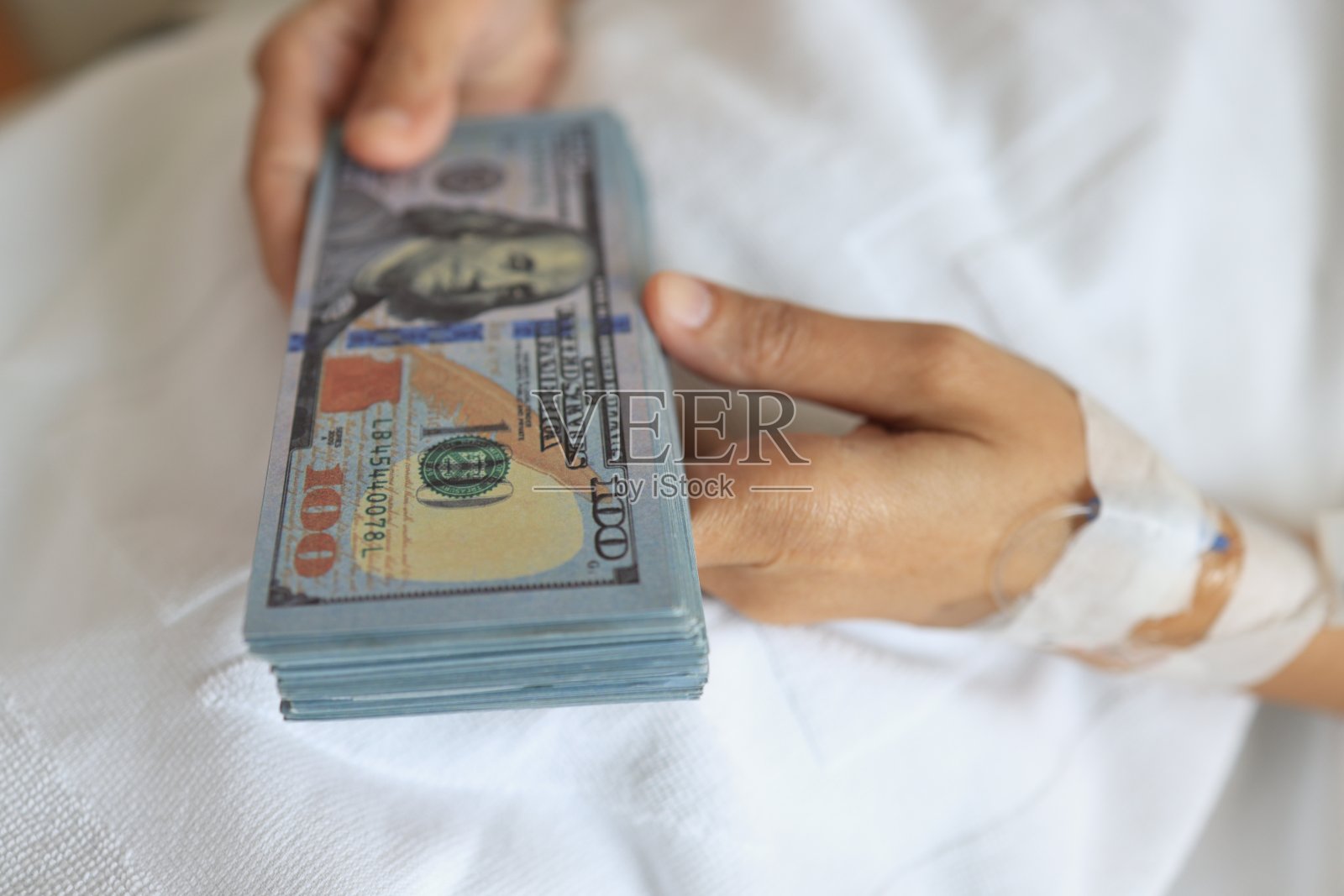 病人受伤医院病床上的一名妇女从保险公司获得保险金后收到了美元照片摄影图片